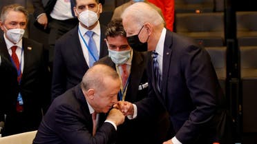 Turkey's President Recep Tayyip Erdogan rises from his chair to fist bump US President Joe Biden in Brussels, Belgium, June 14, 2021. (Reuters)