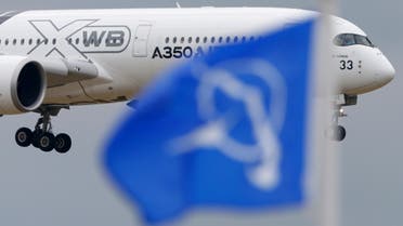 An Airbus A350 flies over a Boeing flag while landing after a flying display during the 51st Paris Air Show at Le Bourget airport near Paris, June 18, 2015. (File Photo: Reuters)