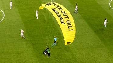 The German players look on as a Greenpeace paraglider lands in the stadium prior to the Euro 2020 soccer championship group F match between France and Germany at the Allianz Arena stadium in Munich, on June 15, 2021. (AP)