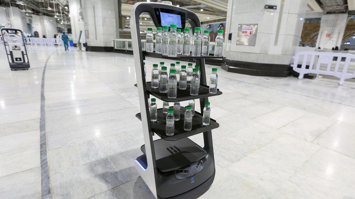 A picture taken on June 15, 2021, shows a smart robot used for the first time at the Grand Mosque in Saudi Arabia's holy city of Mecca, supplying worshippers with bottles of Zamzam water to reduce direct contact with staff as a measure to prevent COVID-19 infections during the yearly hajj pilgrimage. (AFP)