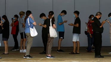 People who had visited a mall which became a coronavirus disease (COVID-19) cluster, queue up for their swab tests in Singapore May 20, 2021. (Reuters)