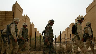 US marines walk through the remake of the palace of King Nebuchadnezzar in the ancient town of Babylon, in this April 20, 2003 file photo. A British Museum report published at the weekend said U.S. troops had caused substantial damage to the ancient city by setting up a military base amid the ruins in April 2003 after invading Iraq and toppling President Saddam Hussein. Polish Defence Minister Jerzy Szmajdzinski said on Monday that contrary to a report by the British Museum, the presence of foreign troops in Babylon had saved the famous archaeological site for civilisation. REUTERS/Jerry Lampen JFL/THI
