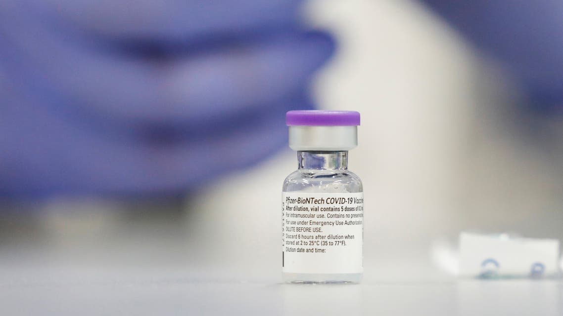 FILE PHOTO: A vial of the Pfizer vaccine against the coronavirus disease (COVID-19) is seen as medical staff are vaccinated at Sheba Medical Center in Ramat Gan, Israel December 19, 2020. Picture taken December 19, 2020. REUTERS/Amir Cohen/File Photo