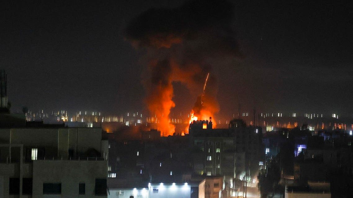 Explosions light-up the night sky above buildings in Gaza City as Israeli forces shell the Palestinian enclave, early on June 16, 2021. (AFP)