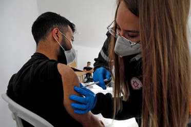 A health worker administers a dose of the Pfizer-BioNtech COVID-19 coronavirus vaccine at a mobile clinic near Moshav Dalton in northern Israel on February 22, 2021. (File photo: AFP)