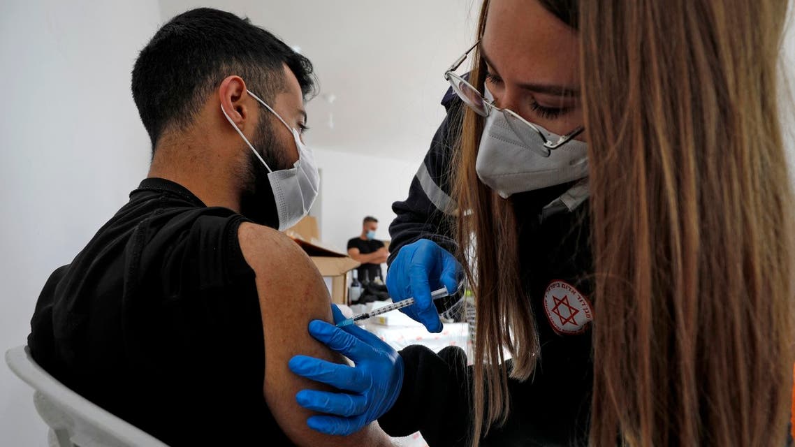 A health worker administers a dose of the Pfizer-BioNtech COVID-19 coronavirus vaccine at a mobile clinic near Moshav Dalton in northern Israel on February 22, 2021.