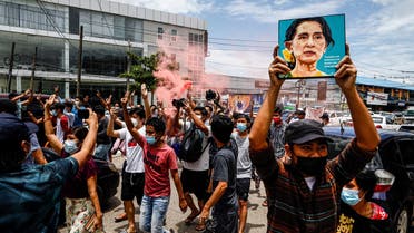 A protester holds up a painting of Myanmar's detained civilian leader Aung San Suu Kyi to mark her birthday during a demonstration against the military coup in Yangon on June 19, 2021.