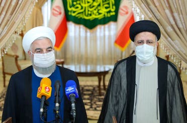 A handout picture provided by the Iranian presidency on June 19, 2021, shows outgoing President Hassan Rouhani (L) taking in part in a press conference with President-elect Ebrahim Raisi (R) during his visit to congratulate the ultraconservative cleric on winning the presidential election. (Reuters)