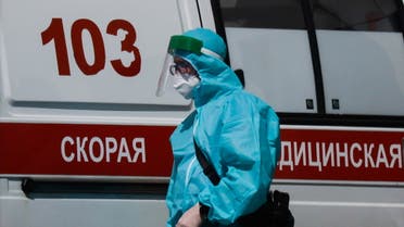 A medical specialist walks by an ambulance outside a hospital for patients infected with the coronavirus disease (COVID-19) in Moscow, Russia June 16, 2021. (Reuters)