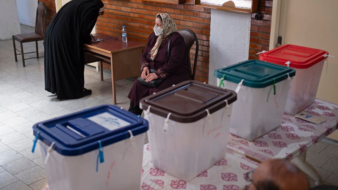 An woman fills her registration form before voting at a polling station located in a school for Tehran's minority Christian community, on the day of the Islamic republic's presidential election on June 18, 2021. Iranian voters cast their ballots today in a presidential election in which ultraconservative cleric Ebrahim Raisi is seen all but certain to coast to victory after all serious rivals were barred from running.