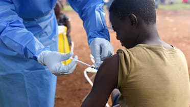 FILE PHOTO: A Congolese health worker administers Ebola vaccine to a boy who had contact with an Ebola sufferer in the village of Mangina in North Kivu province of the Democratic Republic of Congo, August 18, 2018. REUTERS/Olivia Acland//File Photo