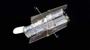 This 1997 NASA file image shows the Hubble Space Telescope as seen by the Space Shuttle Discovery as she performed a flyaround of the Hubble Space Telescope (HST) after redeployment on the second servicing mission designated HST SM-02. The silvery telescope, with its aperture door open, is sharply contrasted by the velvety blackness of space. AFP PHOTO/ NASA