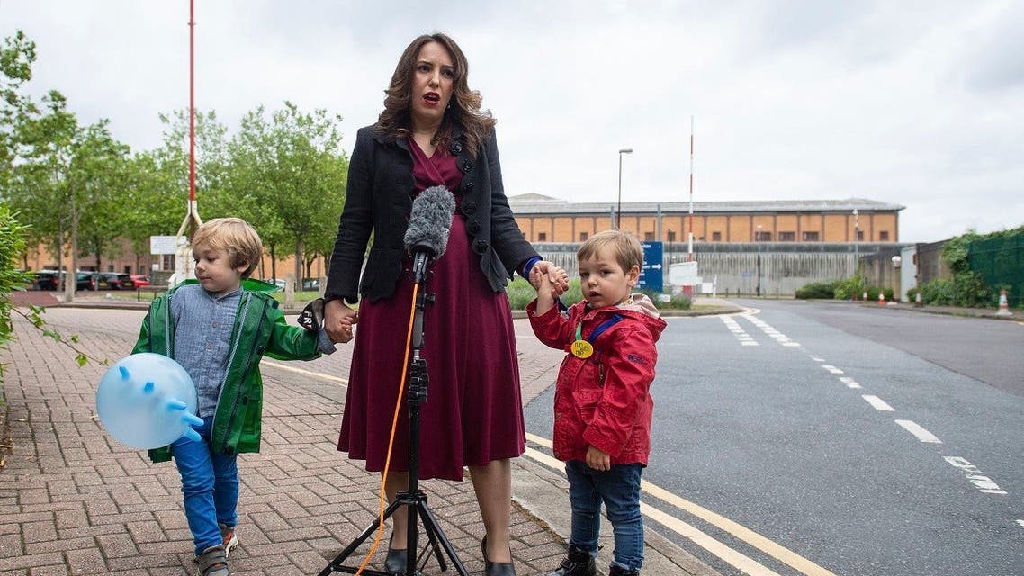 Stella Moris stands with her children Gabriel, four, left, and Max, two, as she speaks to the media, outside Belmarsh Prison, following a visit to her partner and their father Julian Assange in London, Saturday June 19, 2021. (Dominic Lipinski/PA via AP)