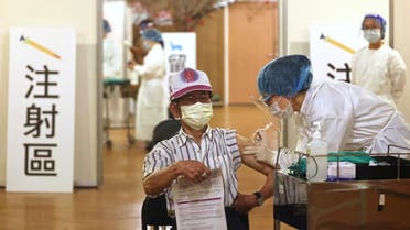 A medical worker administers a dose of the AstraZeneca vaccine against the coronavirus disease (COVID-19) to a man during a vaccination session for elderly people over 85 years old, at a Buddhist temple in New Taipei City, Taiwan, June 16, 2021. (Reuters)
