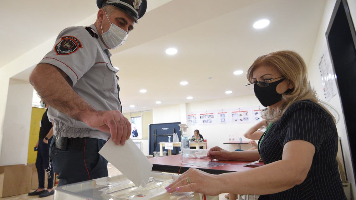 serviceman casts his ballot at a polling station during early parliamentary elections in Yerevan on June 20, 2021. (AFP)