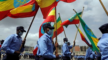 Addis Ababa police officers holding the Ethiopian national flags, take part in a parade to display their new uniforms, and their readiness for the upcoming Ethiopian parliamentary and regional elections, in Addis Ababa, Ethiopia, June 19, 2021. (Reuters)