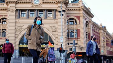 Pedestrians cross the road at Flinders Street Station on the first day of eased coronavirus disease (COVID-19) restrictions for the state of Victoria following an extended lockdown in Melbourne, Australia, June 11, 2021. (Reuters)
