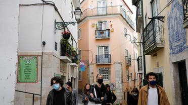 Tourists walk in Alfama neighbourhood amid the coronavirus disease (COVID-19) pandemic, in Lisbon, Portugal, March 11, 2021. (Reuters)