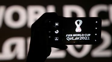 A man takes a picture of the tournament's official logo for the 2022 Qatar World Cup as displayed on the wall of amphitheater, in Doha, Qatar, September 3, 2019. (Reuters)