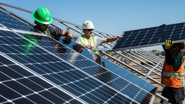 Workers putting up solar panels. (File photo: Unsplash, Science in HD)