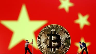 Small toy figurines are seen on representations of the Bitcoin virtual currency displayed in front of an image of China's flag in this illustration picture, April 9, 2019. (File Photo: Reuters)