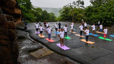 People take part in a yoga session at the Kanheri Caves on the outskirts of Mumbai on June 21, 2021, to mark International Yoga Day. (AFP)