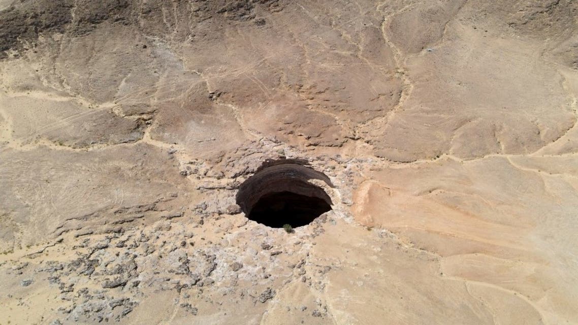 An aerial view on June 6, 2021 shows the Well of Barhout known as the Well of Hell in the desert of Yemen's Al-Mahra province. Closer to the border with Oman than to the capital Sanaa 1,300 kilometres (800 miles) away, the giant hole in the desert of Al-Mahra province is 30 metres wide and thought to be anywhere between 100 and 250 metres deep. Local folklore says it was created as a prison for the demons -- a reputation bolstered by the foul odours rising from its depths. (AFP)