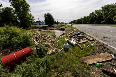 Debris sits along a creek and roadway in Northport, Alabama, Sunday, June 20, 2021. Tropical Depression Claudette has claimed 12 lives in Alabama as the storm swept across the southeastern US, causing flash flooding and spurring tornadoes that destroyed dozens of homes. (AP)