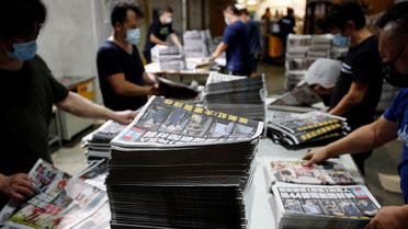 Workers prepare copies of Apple Daily newspaper at its printing facility for distribution after police raided its newsroom and arrested five executives the day before, in Hong Kong, China early June 18, 2021. (Reuters)