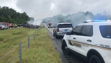 Smoke rises from the wreckage after about 18 vehicles slammed together on a rain-drenched Alabama highway during Tropical Storm Claudette, in Butler County, Alabama, US, June 19, 2021. (Reuters)
