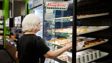 A customer buys Krispy Kreme doughnuts at a Walmart to Go convenience store which is open on a trial basis in Bentonville, Arkansas, US. (Reuters)