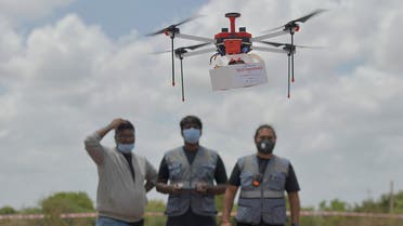 Technicians fly a drone belonging to the Throttle Aerospace Systems (TAS) which flies Beyond Visual Line of Sight (BVLOS) to deliver life saving medical supplies during a flight testing at Gauribidanur, about 80 km from Bangalore on June 21, 2021. afp