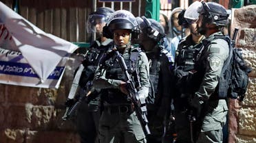 Israeli border guards stand at attention in the east Jerusalem neighbourhood of Sheikh Jarrah on June 21, 2021. (AFP)