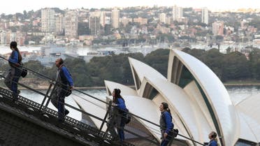 People climb the Sydney Harbour Bridge above the Sydney Opera House on a guided excursion in Sydney. (Reuters)
