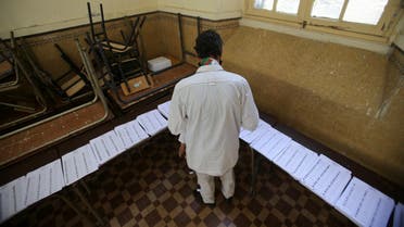 A voter looks at ballots at a polling station during the parliamentary election, in Algiers, Algeria June 12, 2021. (AFP)