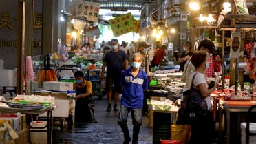People wearing protective face masks shop at a market amid the coronavirus disease (COVID-19) pandemic, in Taipei, Taiwan, June 8, 2021. (Reuters)
