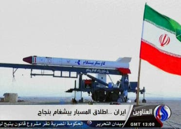 An image grab taken from Iran's Al-Alam TV on January 28, 2013, shows the Iranian flag at an unknown location flying in front of a capsule containing a live monkey which the Tehran-based Arab-language channel said they sent up into space and later retrieved intact. (AFP)