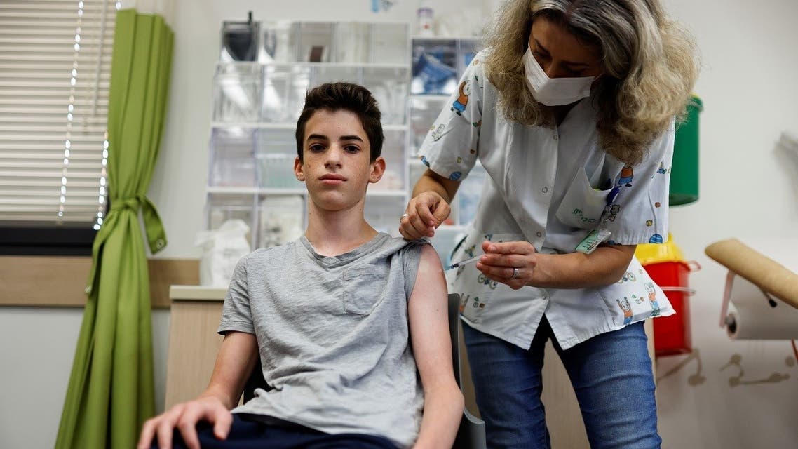 A teenager receives a dose of a vaccine against the coronavirus as Israel cites new outbreaks attributed to the more infectious Delta variant at a Clalit healthcare maintenance organization in Tel Aviv, Israel June 21, 2021. (Reuters/Amir Cohen)