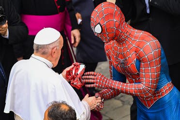 Mattia Villardita who is wearing a costume of the Spider-Man hands a Spider-Man mask to Pope Francis as they meet at the end of the weekly general audience on June 23, 2021 at San Damaso courtyard in The Vatican. (Alberto Pizzoli/AFP)