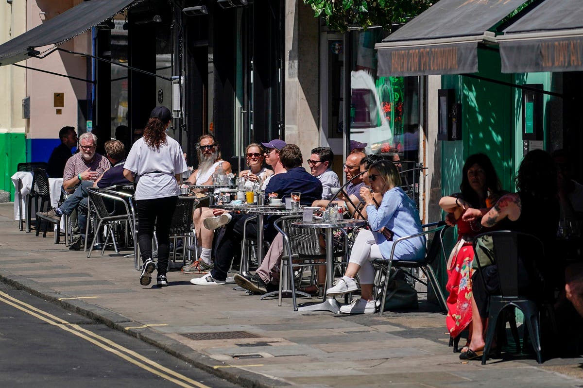 People sit at outdoor tables at a restaurant in Soho, in London, June 14, 2021. (AP/Alberto Pezzali)