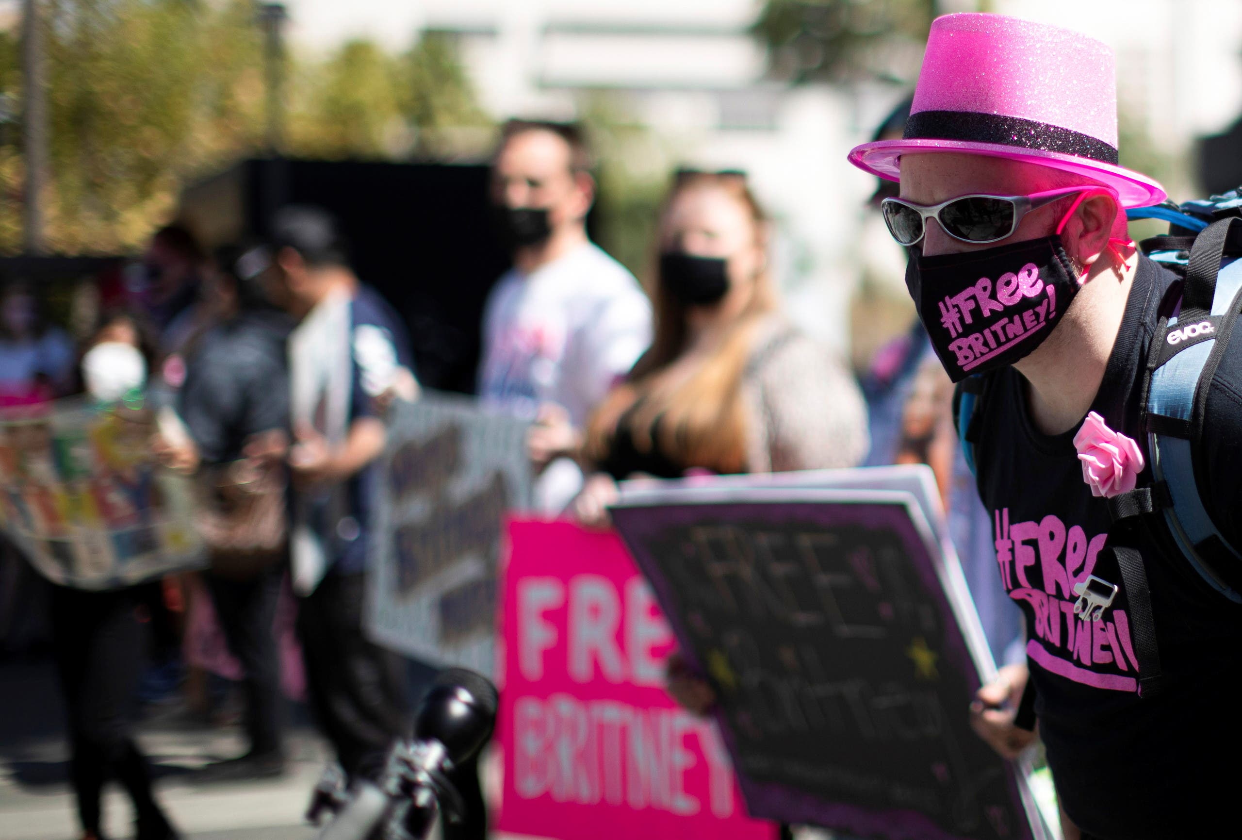 A supporter wearing a personal protective masks rallies for pop star Britney Spears during a conservatorship case hearing at Stanley Mosk Courthouse in Los Angeles, California, US, March 17, 2021. (Reuters)
