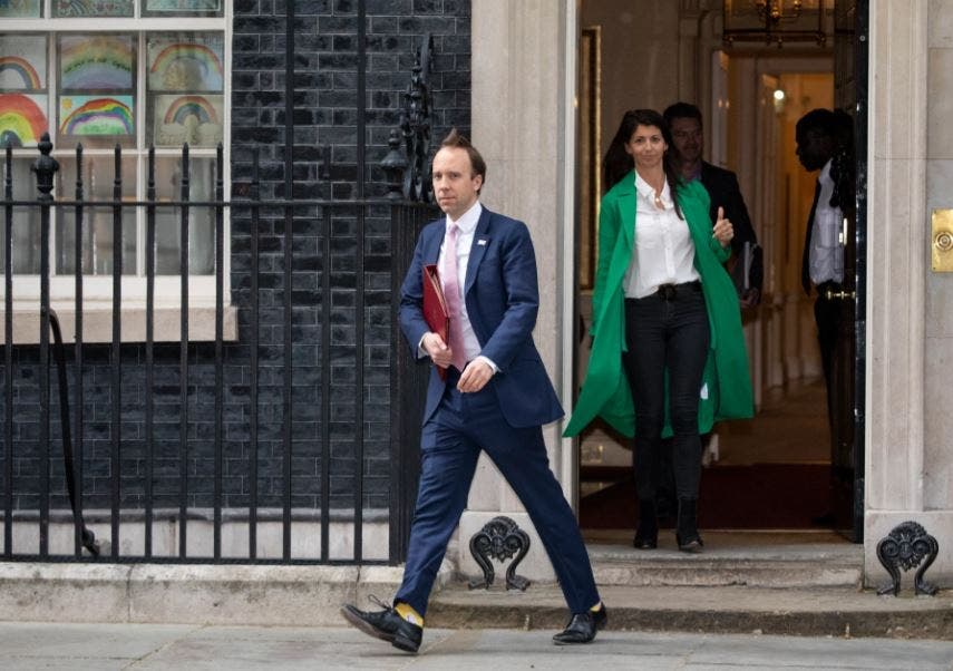 Hanok as he exits Government House, followed in the back by Gina (The Sun)