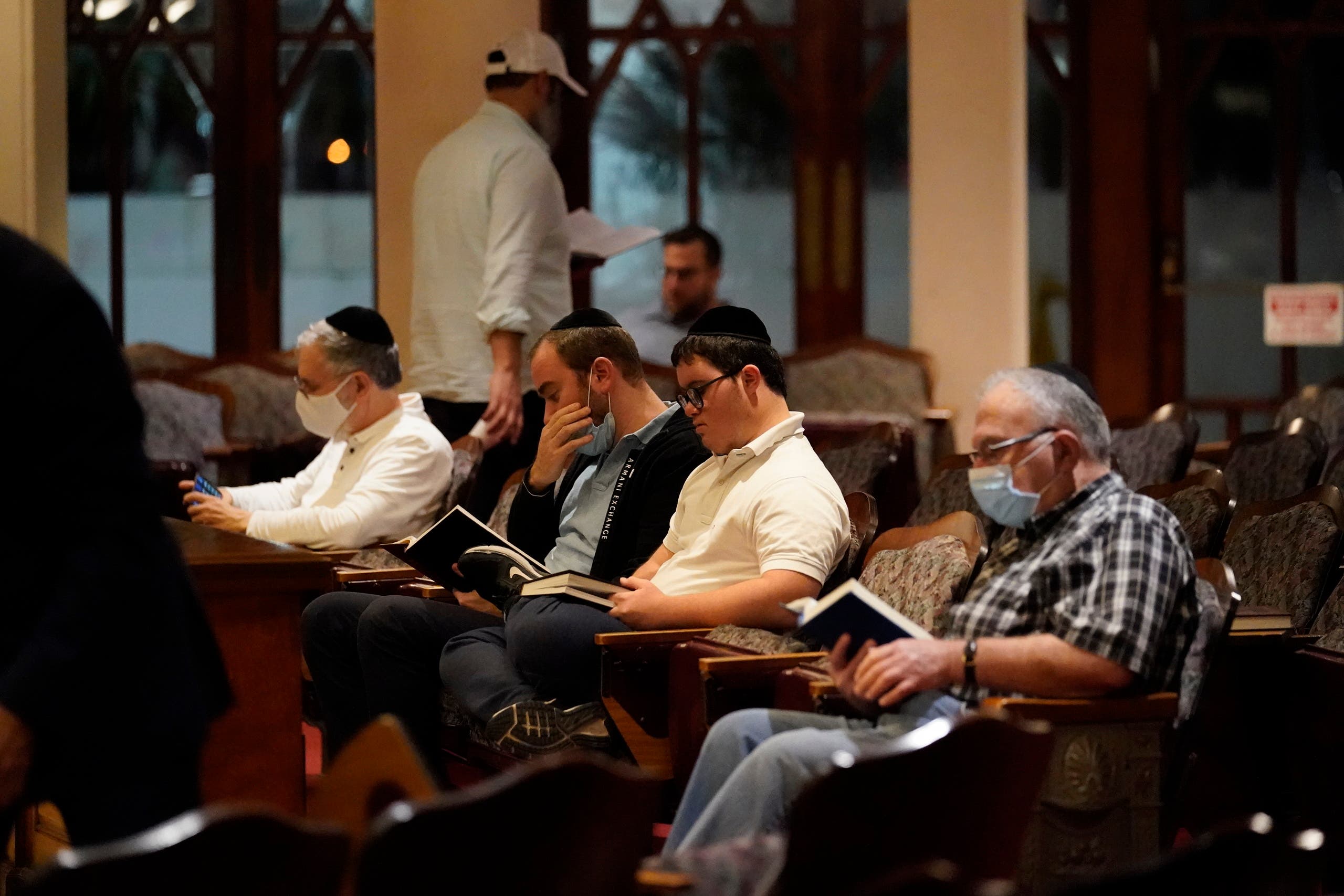 Jewish faithful pray at the Shul of Bal Harbour after members of the community were reported missing in the partial collapse of a 12-story beachfront condo, Thursday, June 24, 2021, in the Surfside area of Miami. (AP)