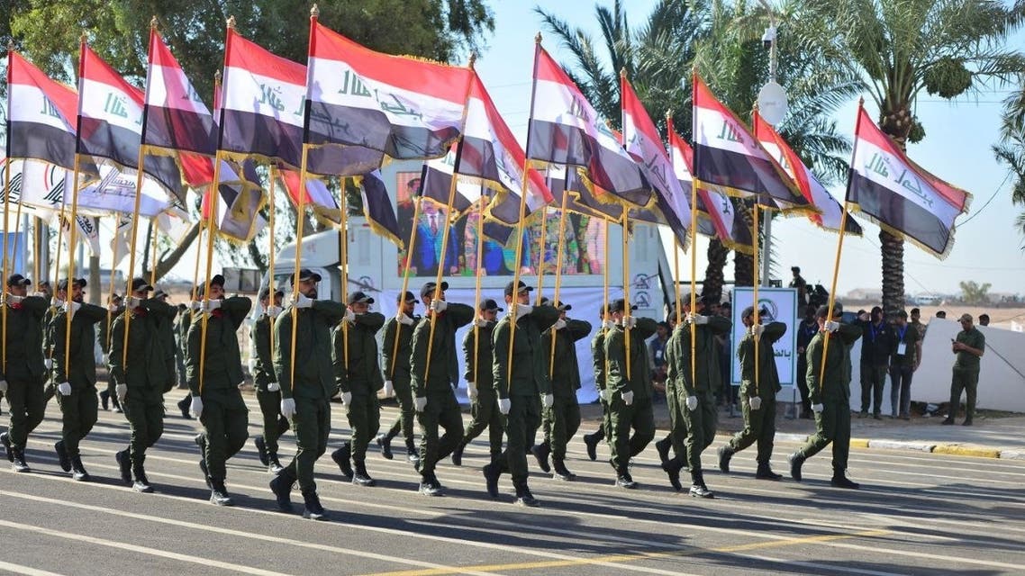 A handout picture released by the Hashed al-Shaabi force shows members of the Iranian-backed Hashed al-Shaabi paramilitary forces taking part in a parade to celebrate the 7th anniversary of their founding at Camp Ashraf (a former base of Iran's opposition People's Mujaheddin Party) in Khalis, in the Diyala province, on June 26, 2021. Hashed al-Shaabi Media / AFP
