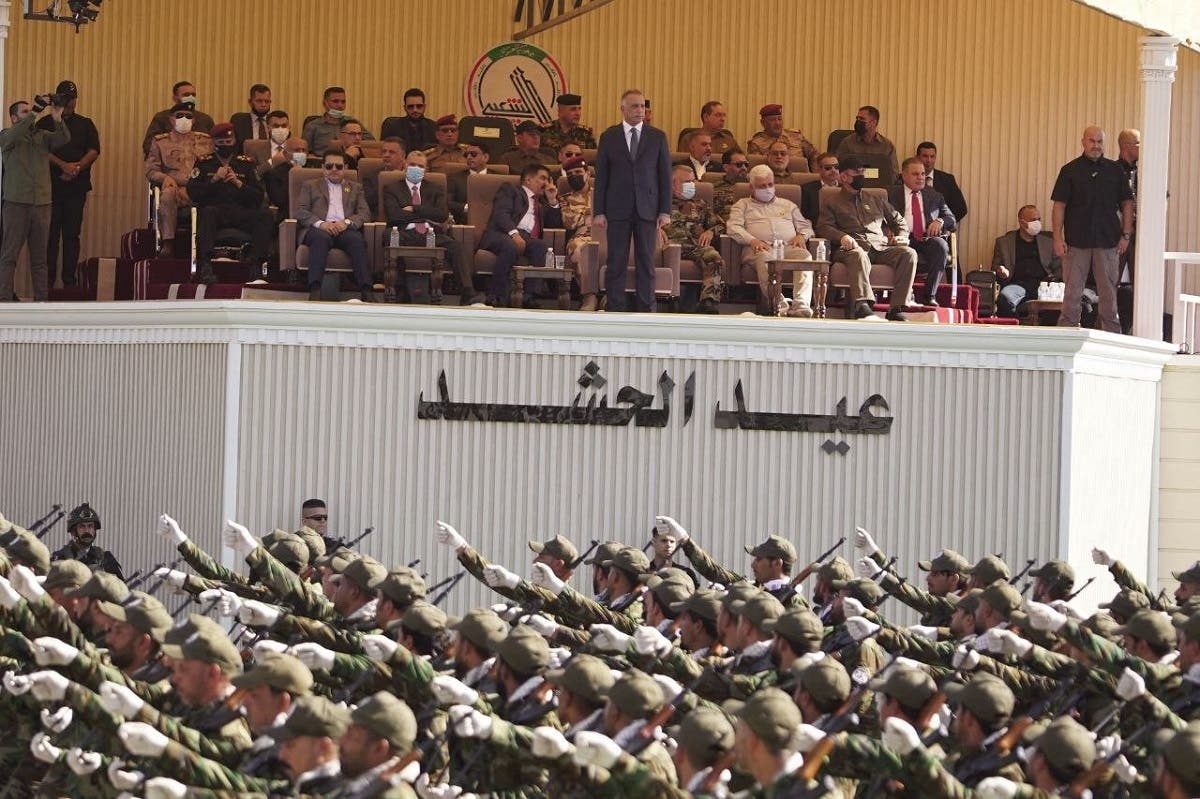 A handout picture shows Iraqi PM al-Kadhemi attends a parade by members of the Iranian-backed Popular Mobilization Units, celebrating the 7th anniversary of their founding at Camp Ashraf in Khalis, in the Diyala province, June 26, 2021. (Hashed al-Shaabi Media/AFP)