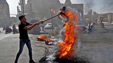 Demonstrators burn tires to block the Martyrs' Square in the centre of Lebanon's capital Beirut on June 26, 2021, as they protest against dire living conditions amidst the ongoing economical and political crisis. (AFP)