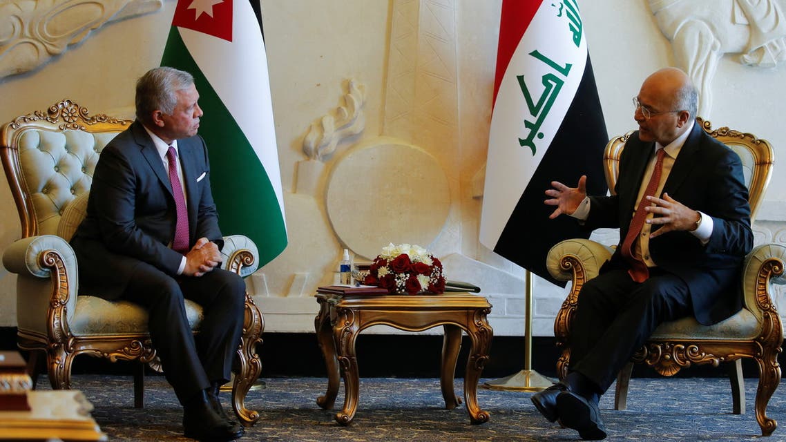 Iraqi President Barham Salih and King Abdullah II of Jordan talk at Baghdad International Airport in Baghdad, Iraq June 27, 2021. (Reuters)