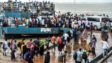 People crowd to board a ferry as authorities ordered a new lockdown to contain the spread of the Covid-19 coronavirus, in Munshiganj on June 27, 2021. (Munir Uz zaman/AFP)