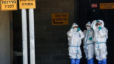 Health workers wear protective suits to protect themselves against COVID-19, near Tel Aviv, Israel April 28, 2021. (Reuters)
