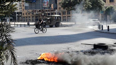 Demonstrators burn tires to block a main road in the centre of Lebanon's capital Beirut on June 26, 2021, as they protest against dire living conditions amidst the ongoing economical and political crisis. (AFP)
